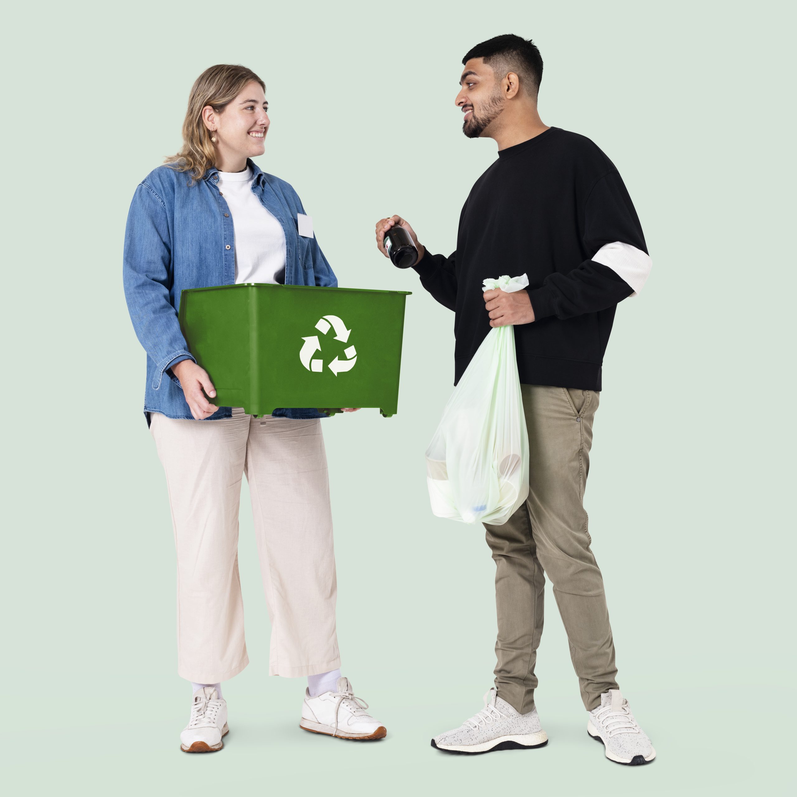 Beach cleanup volunteer with recycle bin save the earth campaign